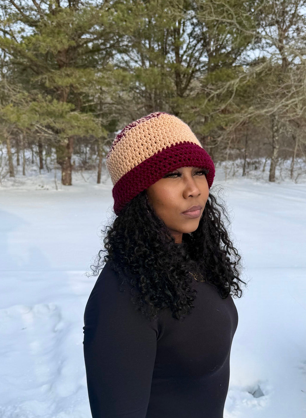 Brown and burgundy oversize beanie, soft stretchy acrylic, worn by woman in snowy outdoor setting.